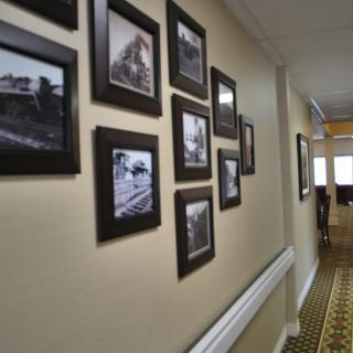 A hallway adorned with a collection of black and white framed photographs.