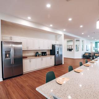 A spacious and modern kitchen featuring sleek appliances and a large dining area.