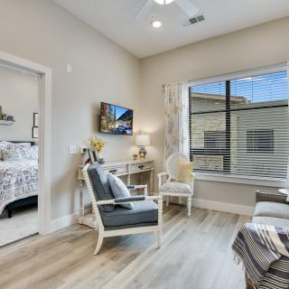 A modern, cozy living room with ample natural lighting and elegant decor.