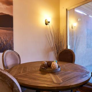Cozy dining area with a wooden round table and stylish decor.