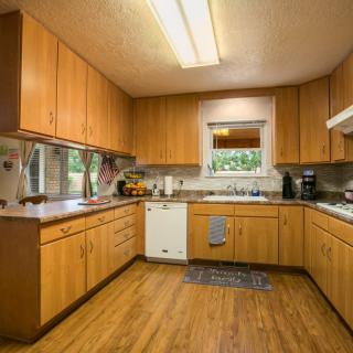 A cozy kitchen with wooden cabinets and modern appliances.