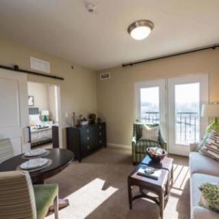 A cozy and modern living room with ample natural light and a view of the balcony.