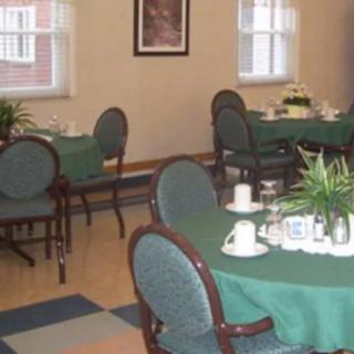A neatly arranged dining room with tables set for service.