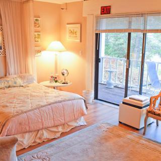 A cozy bedroom with soft lighting and access to a balcony.