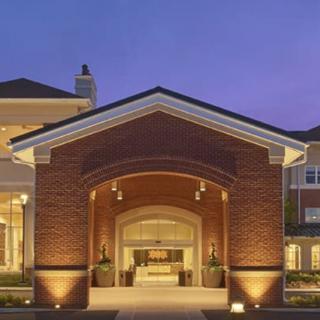 Illuminated entrance of a brick building at night.