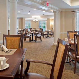 An elegant dining area with neatly arranged tables and chairs, featuring a warm and welcoming atmosphere.