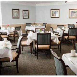 An empty dining room with tables set for guests.