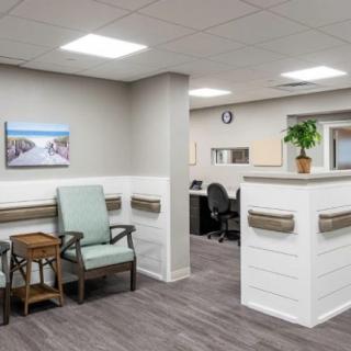 A modern and clean waiting area with seating and a reception desk.