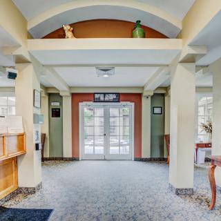 A spacious lobby area with an inviting entrance featuring double doors and decorative architectural elements.
