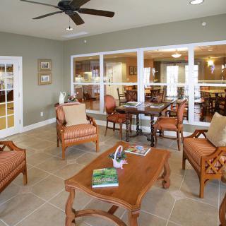 A comfortable living room with elegant furniture and large windows.