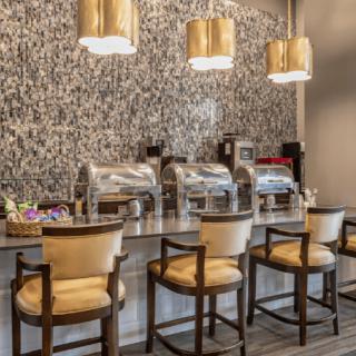 A stylish buffet counter with comfortable seating and elegant lighting.