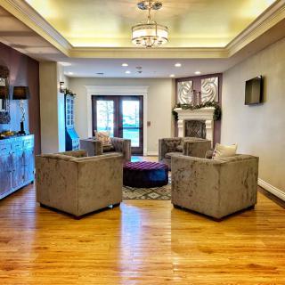 A modern living room with comfortable seating and a cozy fireplace.