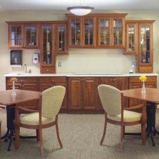 A cozy kitchen and dining area with wooden cabinets and comfortable seating.