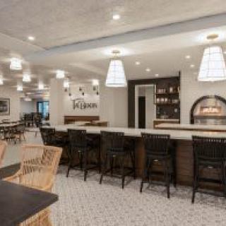 A modern bar and restaurant interior with stylish seating and lighting.
