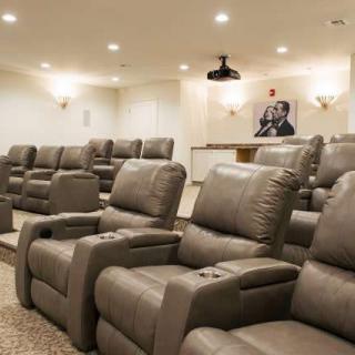 A modern home theater with comfortable recliner seating and a projector for an immersive viewing experience.