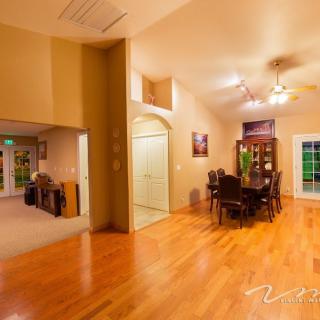 A warm and inviting dining area with hardwood floors and elegant furniture.