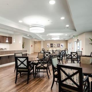 A modern dining area with elegant furnishings and ambient lighting.