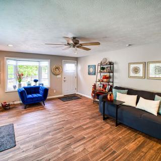 Modern living room with a comfortable sofa, armchair, and wood flooring.