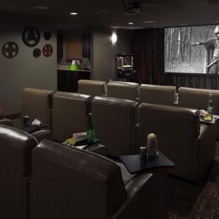 A cozy home theater setup with comfortable seating and a large screen.