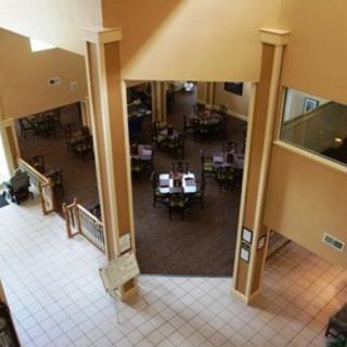Spacious interior view of a restaurant with a dining area and multiple tables.