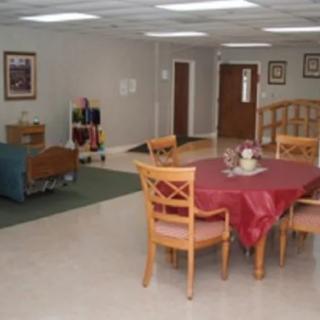 A simple, tidy interior space featuring a dining table with chairs and cozy seating area.
