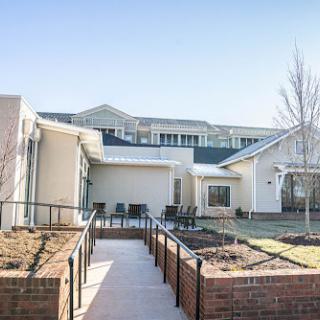 A serene view of a modern residential complex with well-maintained gardens and pathways.