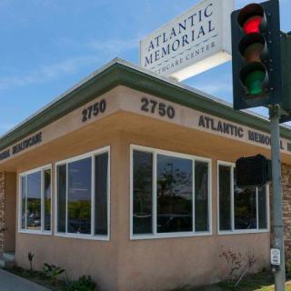 A funeral home located at a street corner with a visible traffic light.