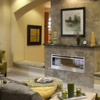 A modern living room featuring a stylish fireplace and contemporary artwork.