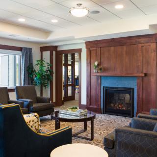 A modern and cozy living room with a fireplace and comfortable seating.