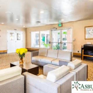 A bright and welcoming lobby with comfortable seating and decorative flowers.