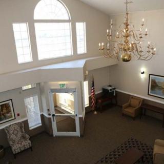 A spacious lobby with a chandelier and comfortable seating area.