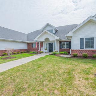 A charming residential home with well-maintained landscaping and a welcoming entrance.