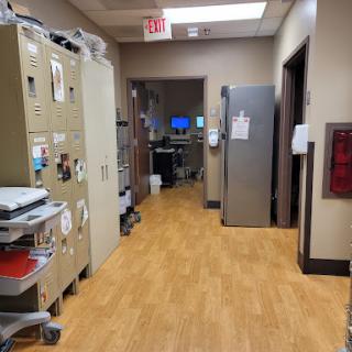 A corridor in a hospital featuring medical equipment and facilities.