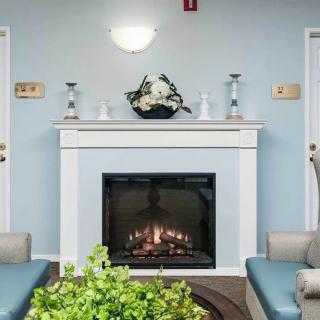 A modern and cozy living room with a fireplace, stylish decor, and comfortable seating.