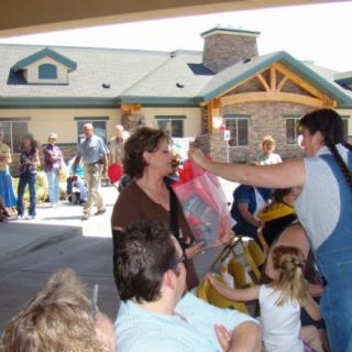 A group of people enjoying an outdoor gathering with children and families.