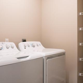 A laundry room with a washing machine and dryer ready for use.
