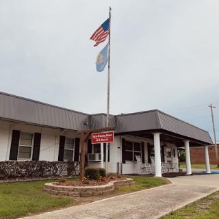 A government building displaying the American flag and a local flag.