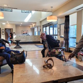 People enjoying their time in a modern hotel lobby.