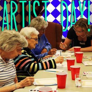 A group of seniors enjoying a painting session on Artist Day.