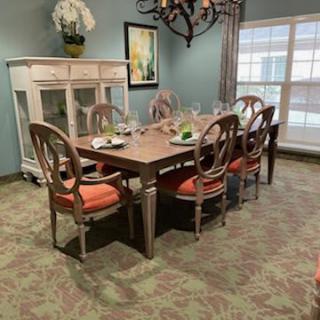 A neatly arranged dining room with a set table and elegant decor.