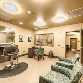 A modern barber shop interior with a stylish waiting area and a barber chair.