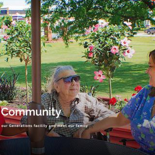 Seniors enjoying a conversation in a vibrant garden setting.