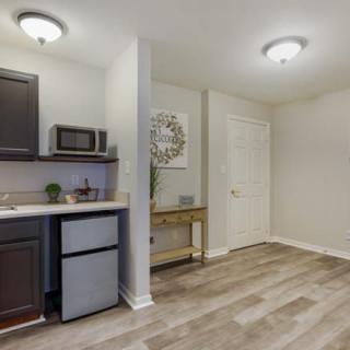 A compact kitchen area with modern amenities and minimalist decor.