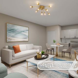 A stylish and modern living room featuring a cozy sofa, elegant coffee table, and a dining area. The neutral color palette enhances the contemporary decor.