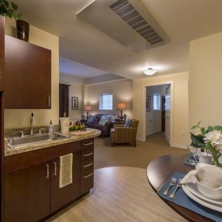 A cozy apartment interior showcasing an open-plan kitchen and living area.