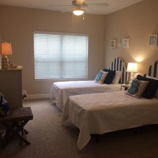 A cozy bedroom with twin beds and modern decor.