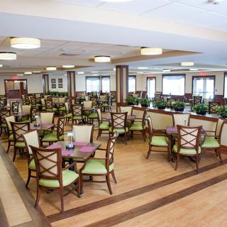 A spacious dining area with neatly arranged tables and chairs.