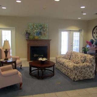 A cozy living room with comfortable seating and a fireplace.