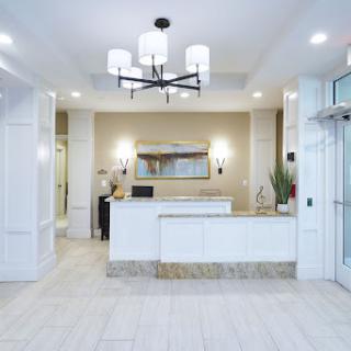 A modern reception area featuring elegant lighting and a stylish front desk.
