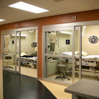 A view of patient rooms in a modern hospital setting.